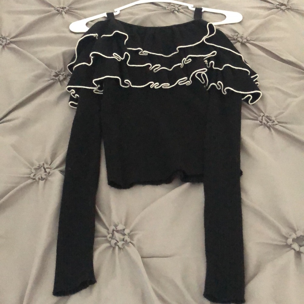 Black ruffled sweater top.
